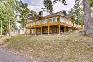 a large wooden house on a hill with trees at Sunrise Beach Home on the Lake of the Ozarks! in Sunrise Beach