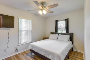 a bedroom with a bed and a ceiling fan at Williston Home with Yard 6 Mi to Devils Den Spring! in Williston