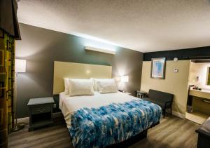 a hotel room with a bed and a sink at Lx Hotel, Manchester, Tennessee in Manchester