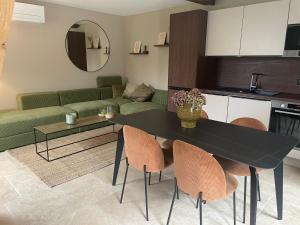 a living room with a black table and chairs at La maison de Mounette in LʼIsle-dʼAbeau +21 photos