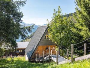 a wooden house with a metal roof in a field at Chalet Huez, 5 pièces, 8 personnes - FR-1-645-14 in LʼHuez