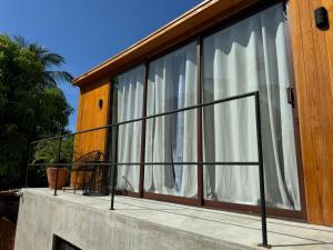 a balcony with white curtains on a house at Naari Cabañas Boutique in Brisas de Zicatela +21 photos