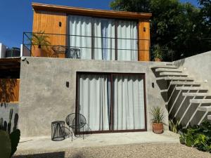 a house with some chairs and a staircase at Naari Cabañas Boutique in Brisas de Zicatela
