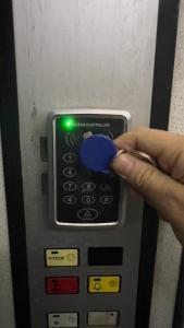 a hand is pushing a blue button on an atm machine at F C Tiranë in Tirana