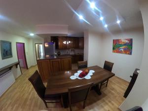 a kitchen and dining room with a table and chairs at F C Tiranë in Tirana +18 photos