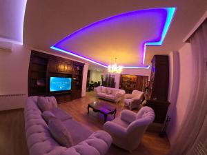 a large living room with couches and a tv at F C Tiranë in Tirana