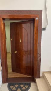 a large wooden door in a room with stairs at F C Tiranë in Tirana
