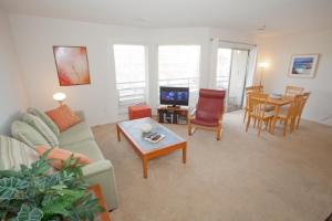 a living room with a couch and a table at Fiddler on the Reef at Playa Rana in Virginia Beach