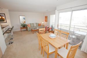 a living room with a table and chairs and a couch at Fiddler on the Reef at Playa Rana in Virginia Beach