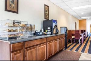 a cafeteria with a counter with aasteryasteryasteryasteryasteryasteryasteryasteryastery at Super 8 by Wyndham Rocky Mount I-95 EXIT 145 in Battleboro