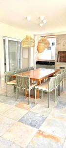 a dining room with a wooden table and chairs at Casa Pipa Flamingos in Pipa