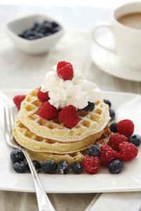 a waffle with berries and whipped cream on a plate at Residence Inn by Marriott Austin Round Rock/Dell Way in Round Rock