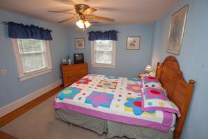 a bedroom with a bed and a ceiling fan at Loraine's Retreat in Virginia Beach
