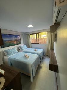 a bedroom with two beds and a table at Barra Grande Exclusive Residence in Barra Grande +33 photos
