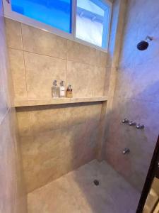 a bathroom with a shower with a sink and a shower at Casa con piscina y salida a la playa in Playas