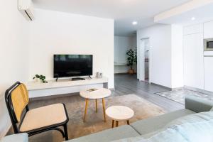 a living room with a couch and a tv at LovelyStay - Boavista Cozy Apartment in Porto