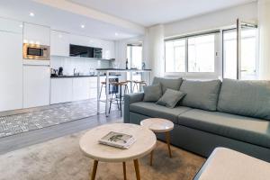 a living room with a couch and a table at LovelyStay - Boavista Cozy Apartment in Porto