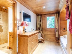 a bedroom in a log cabin with a desk and a window at Chalet Morzine, 7 pièces, 14 personnes - FR-1-754-8 in Morzine