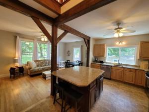 a kitchen and living room with a ceiling fan at Quiet Country Farmhouse in Suwanee