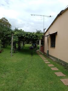 a yard next to a house with trees and grass at La Posada de Ines in Yala
