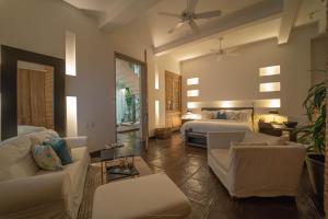 a bedroom with a bed and a living room at Cartagena Old City Mansion in Cartagena de Indias