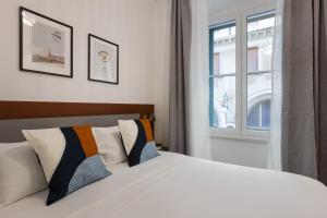 a bedroom with a white bed and a window at Chic Trieste Gem in Trieste