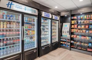 a supermarket aisle with refrigerators and drinks at Staybridge Suites Federal Way - Seattle South , an IHG Hotel in Federal Way