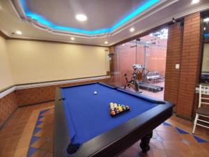 a pool table in a room with at Hotel Troya in Ibarra