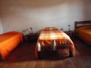 a bedroom with two beds and two lamps on tables at Casa en Barichara: la perfección hecha realidad! in Barichara