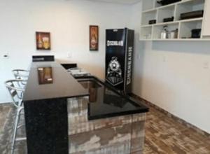 a bar in a room with a drink station at Suite Farol do Arvoredo in Governador Celso Ramos