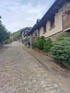 a cobblestone street in front of a house at La Buhardilla de Gavin in Gavín