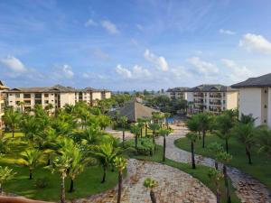 uma vista para um resort com palmeiras e edifícios em VG Sun Cumbuco 406 em Cumbuco