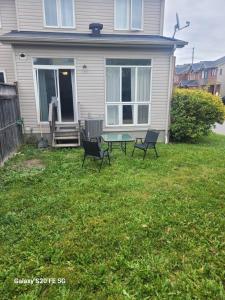 a house with chairs and a table in the yard at Sweet room in Ottawa