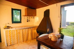 a kitchen with a counter and a table in a room at Casa Binah in Cabo Polonio