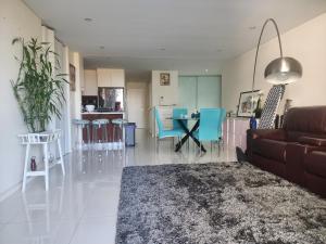 a living room with a couch and a table and chairs at Parramatta Shared Apartment in Sydney