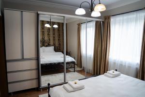 a bedroom with two beds and a mirror at Central Parc Apartment 6 ! Self Check-in ! Free Parking ! WiFi in Suceava