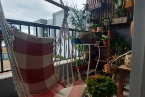 a hammock on a balcony with potted plants at Confortável apt em Parauapebas in Parauapebas