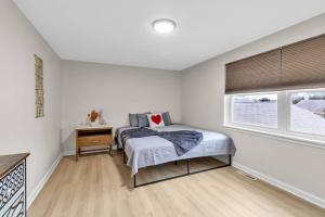 a bedroom with a bed and a window at Downtown & Upscale in Buffalo