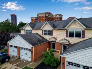 a house with two garages in front of a city at Downtown & Upscale in Buffalo