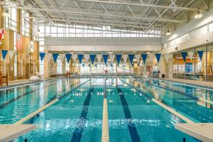 a large indoor swimming pool with blue water at 18 Winding Way in McHenry