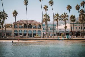 people are standing in the water in front of a building at The Edgewater in Avalon