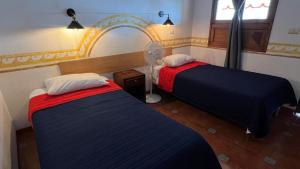 Giường trong phòng chung tại Posada Los Naranjos