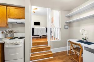 a kitchen with a stairway leading to a dining room at 1 Bdrm Modern Posh Upenndrexel Univ in Philadelphia
