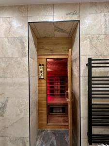 a walk in shower with a glass door in a room at DAS MANFRED in Sankt Michael im Lungau