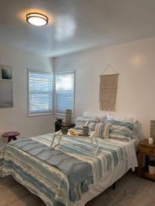 a bedroom with a large bed in a room at Beautiful unit in the heart of Belmont Shores ! in Long Beach