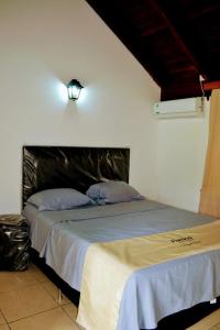 a bedroom with a bed with a light on the wall at Lago Manantial in Independencia