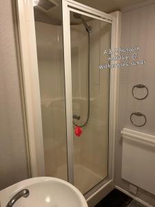 a glass shower in a bathroom with a toilet at AM bargain holidays at Withernsea sands in Withernsea