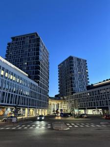 two tall buildings in a city at night at City Apartment Matkatupa in Kuopio