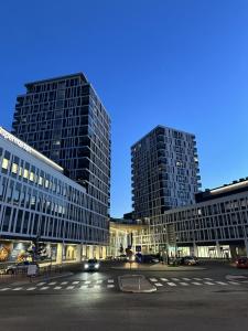 two tall buildings in a city at night at Pramea Apartments Matkatupa in Kuopio