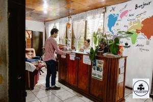 a man is standing at a counter in a store at Hostal Doña Mercedes in Juayúa